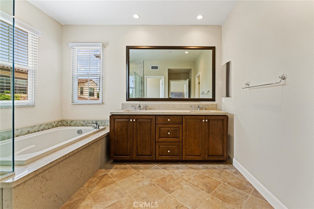 126 Baja Irvine, CA 92620 - Photo 13 of 30 a bathroom with a granite countertop tub double vanity sink and mirror