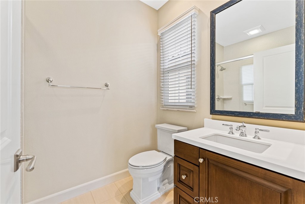 126 Baja Irvine, CA 92620 - Photo 20 of 30 a bathroom with a sink a toilet and a mirror