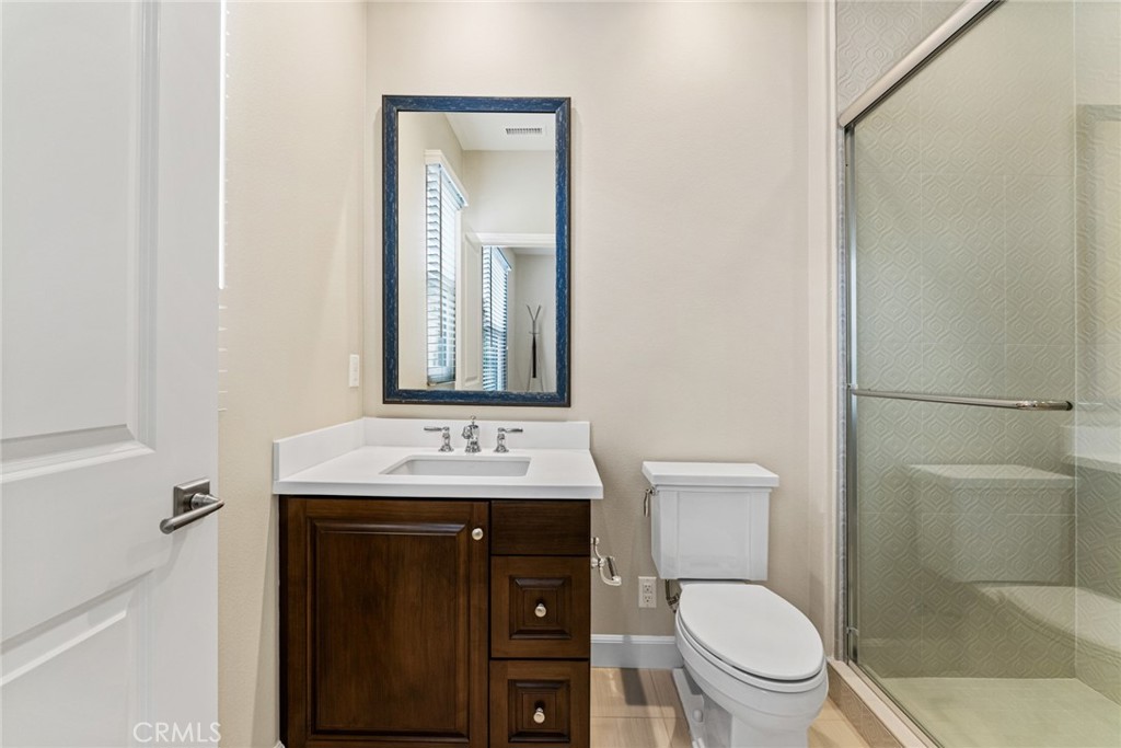 126 Baja Irvine, CA 92620 - Photo 22 of 30 a bathroom with a toilet a sink and mirror