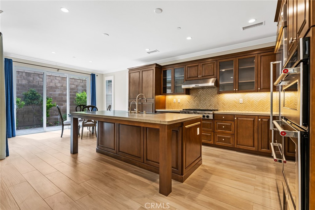 126 Baja Irvine, CA 92620 - Photo 3 of 30 a kitchen with stainless steel appliances granite countertop a stove a sink and a refrigerator