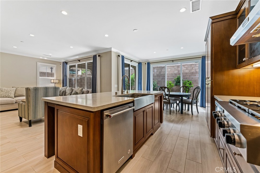 126 Baja Irvine, CA 92620 - Photo 5 of 30 a kitchen with stainless steel appliances granite countertop a stove and a refrigerator