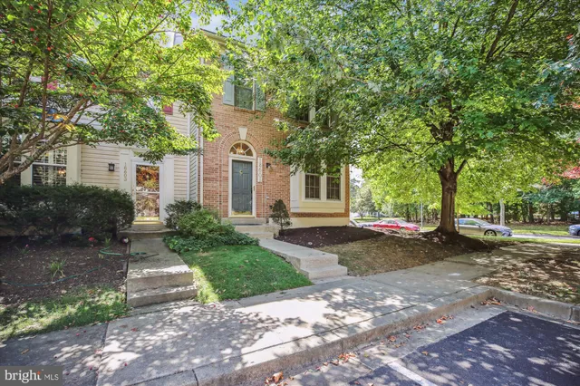 a front view of a house with a yard and a garage