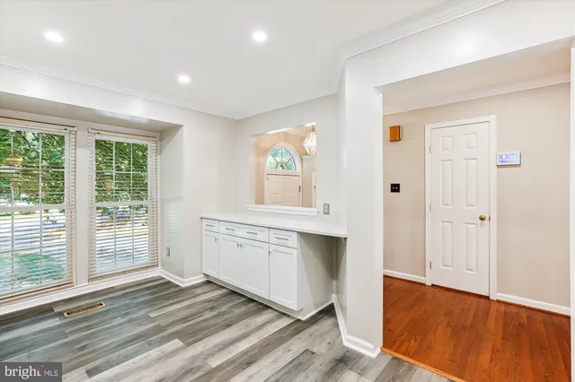 a view of a hallway with wooden floor and stairs