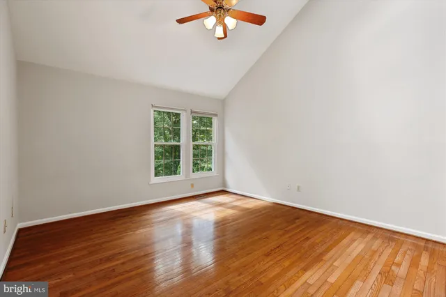 a bathroom with a granite countertop sink toilet mirror and a bathtub