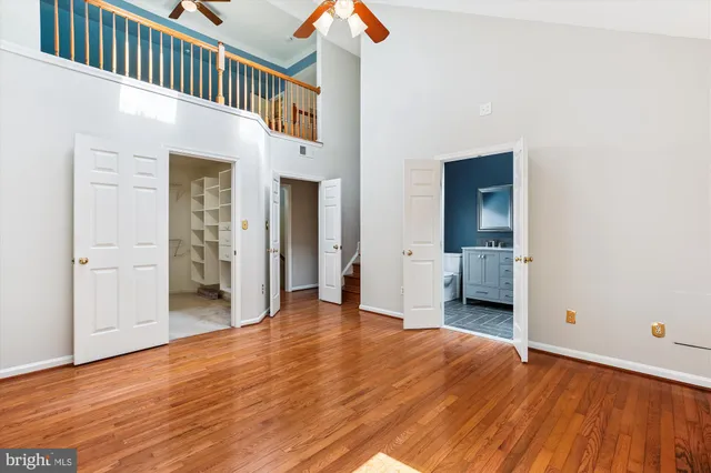 a view of a hallway with a ceiling fan