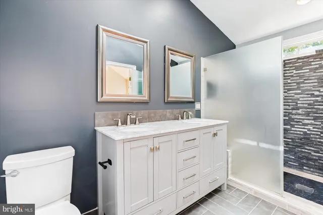 a view of an empty room with a fireplace and a window