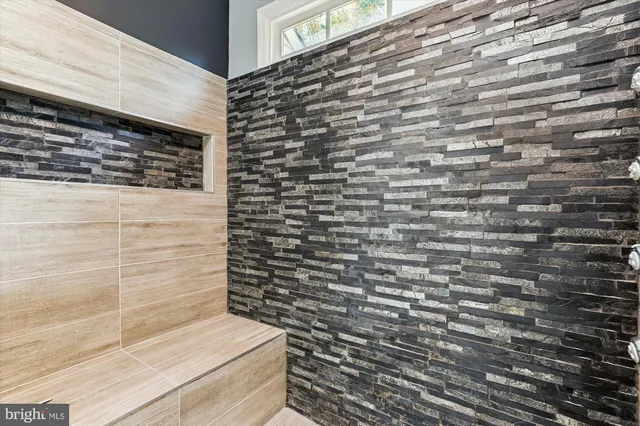 an empty room with windows and fireplace