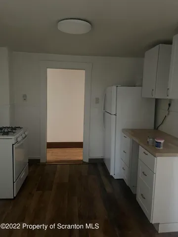a kitchen with a refrigerator stove and cabinets