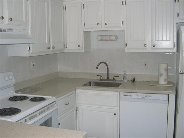 247 Washington, Unit 9 Winthrop, MA 02152 - Photo 3 of 19 a kitchen with white cabinets and a sink
