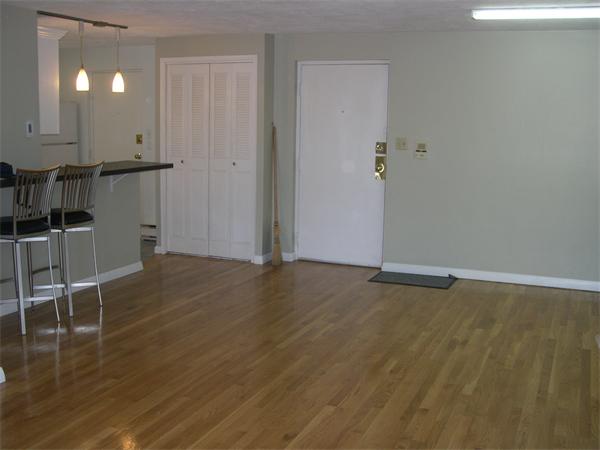 247 Washington, Unit 9 Winthrop, MA 02152 - Photo 8 of 19 an empty room with wooden floor and windows