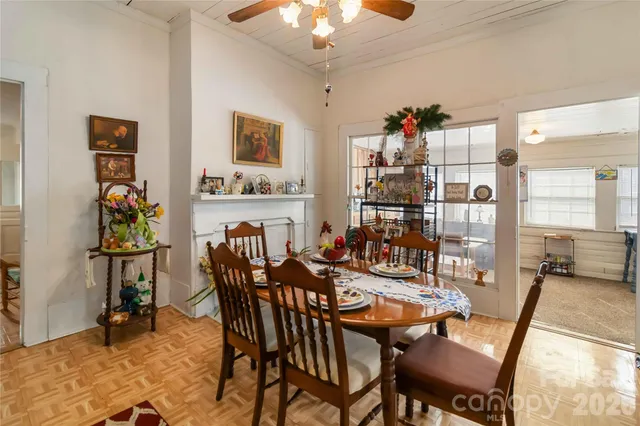 a view of a dining room with furniture and chandelier