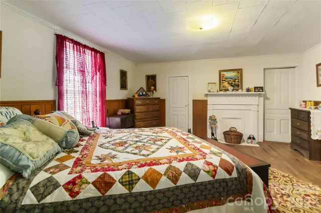 a bedroom with a bed and a fireplace