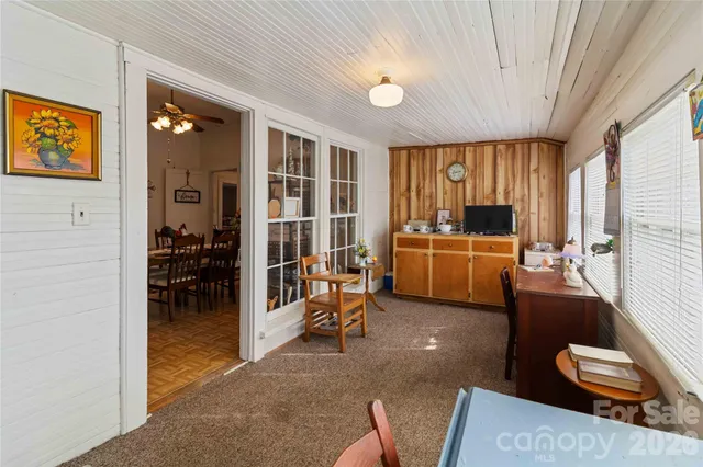 a living room with furniture and large windows