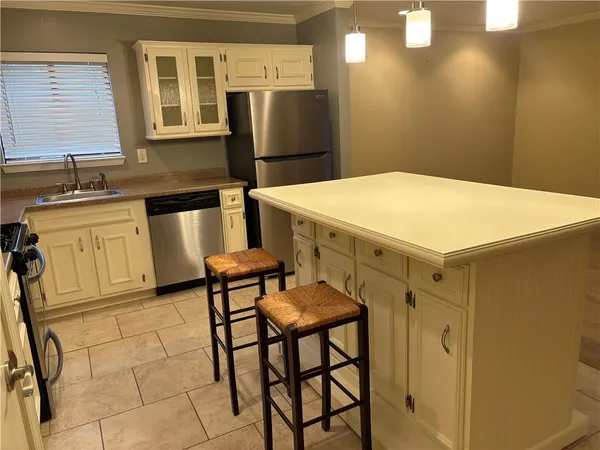 a kitchen with cabinets and stainless steel appliances