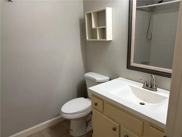 a bathroom with a sink a toilet and mirror