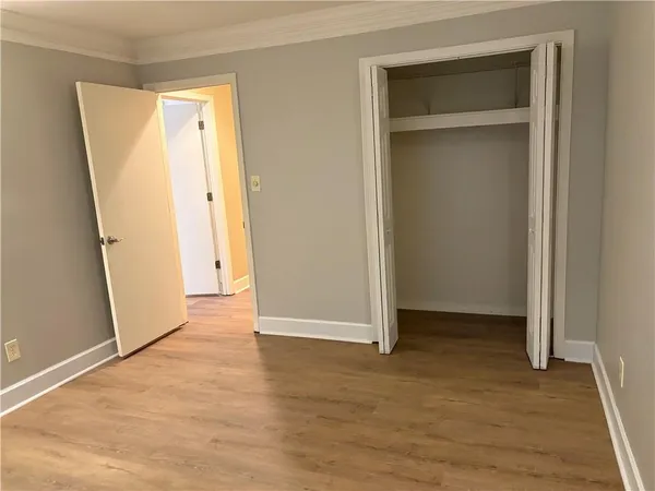 an empty room with wooden floor and a window
