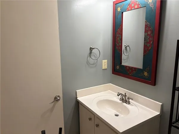 a bathroom with a sink and mirror