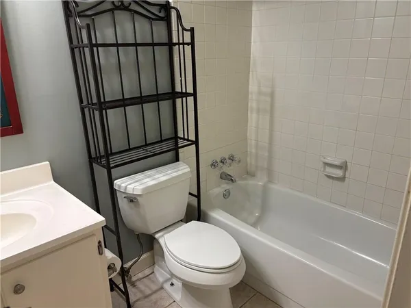 a white toilet sitting next to a bathtub