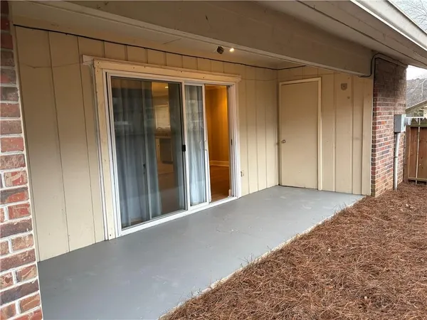 a view of a hallway with wooden floor and closet