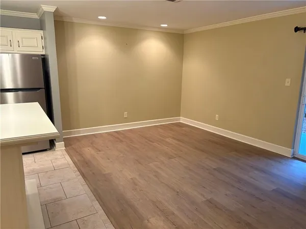 a view of a room with wooden floor and staircase