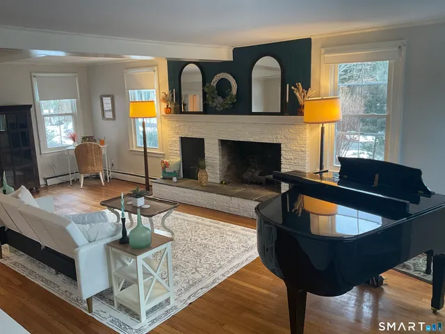 a living room with furniture and a fireplace