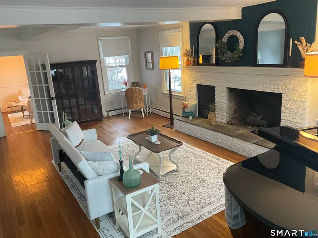 a living room with furniture and a fireplace
