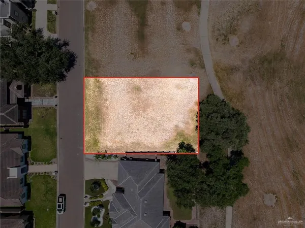 an aerial view of residential house with outdoor space and trees around