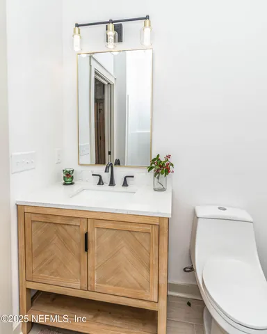 a bathroom with a sink a toilet and mirror