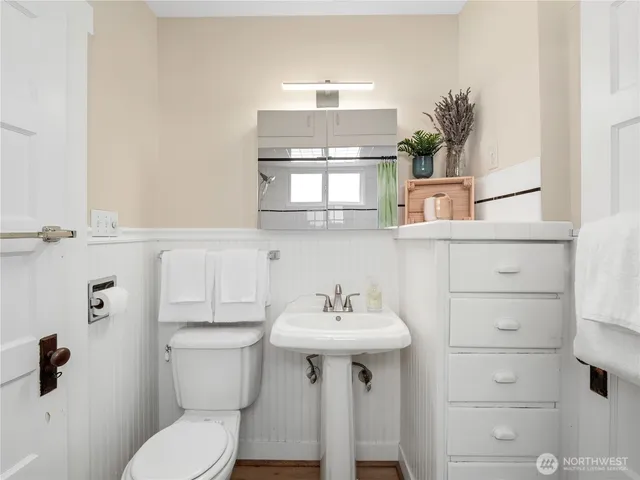 a bathroom with a sink a mirror and a toilet