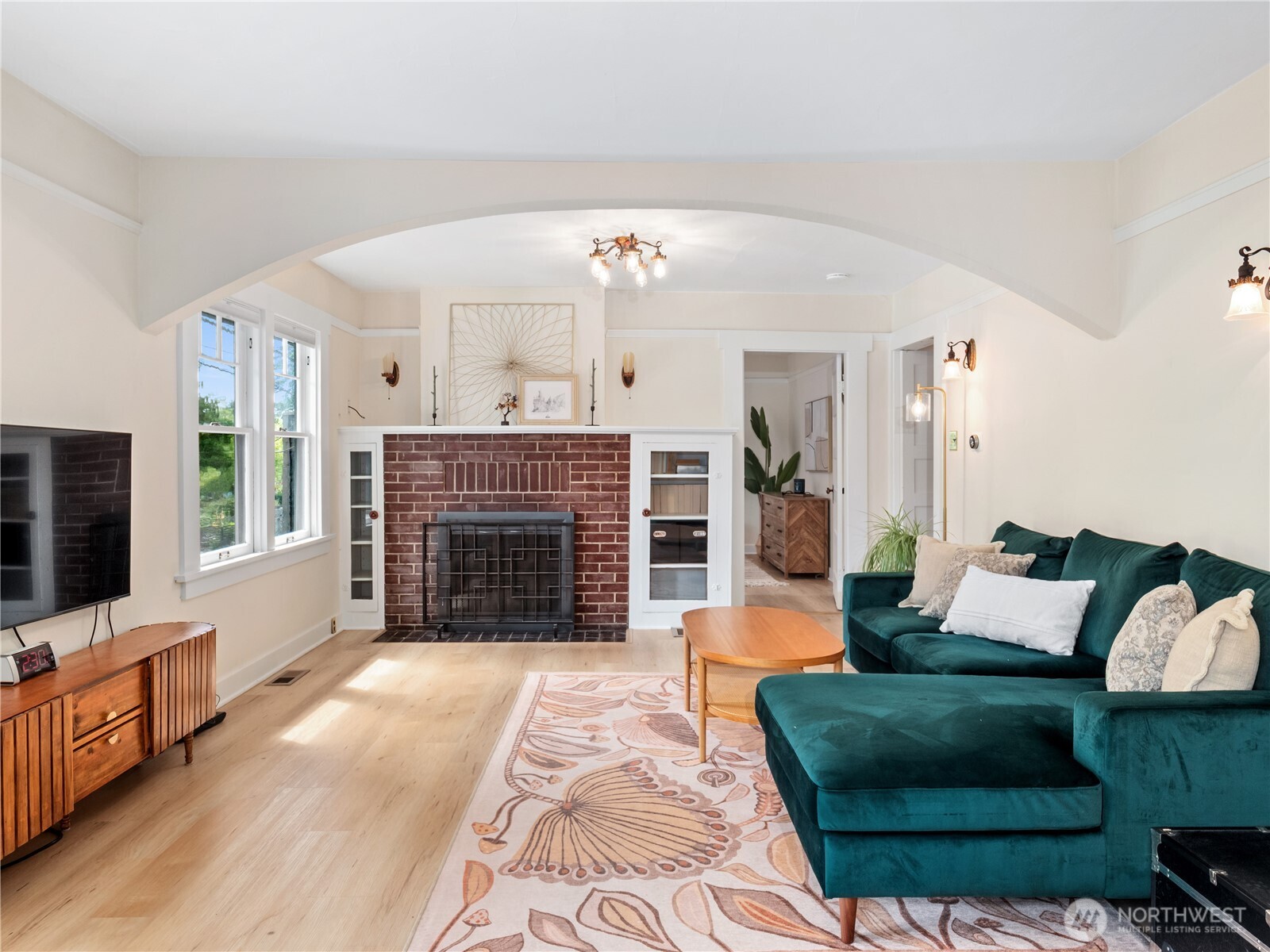 9701 Roosevelt Way Northeast Seattle, WA 98115 - Photo 2 of 33 a living room with furniture a flat screen tv and a fireplace