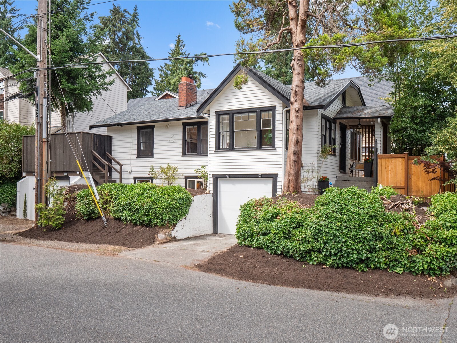 9701 Roosevelt Way Northeast Seattle, WA 98115 - Photo 21 of 33 a front view of a house with a yard and garage