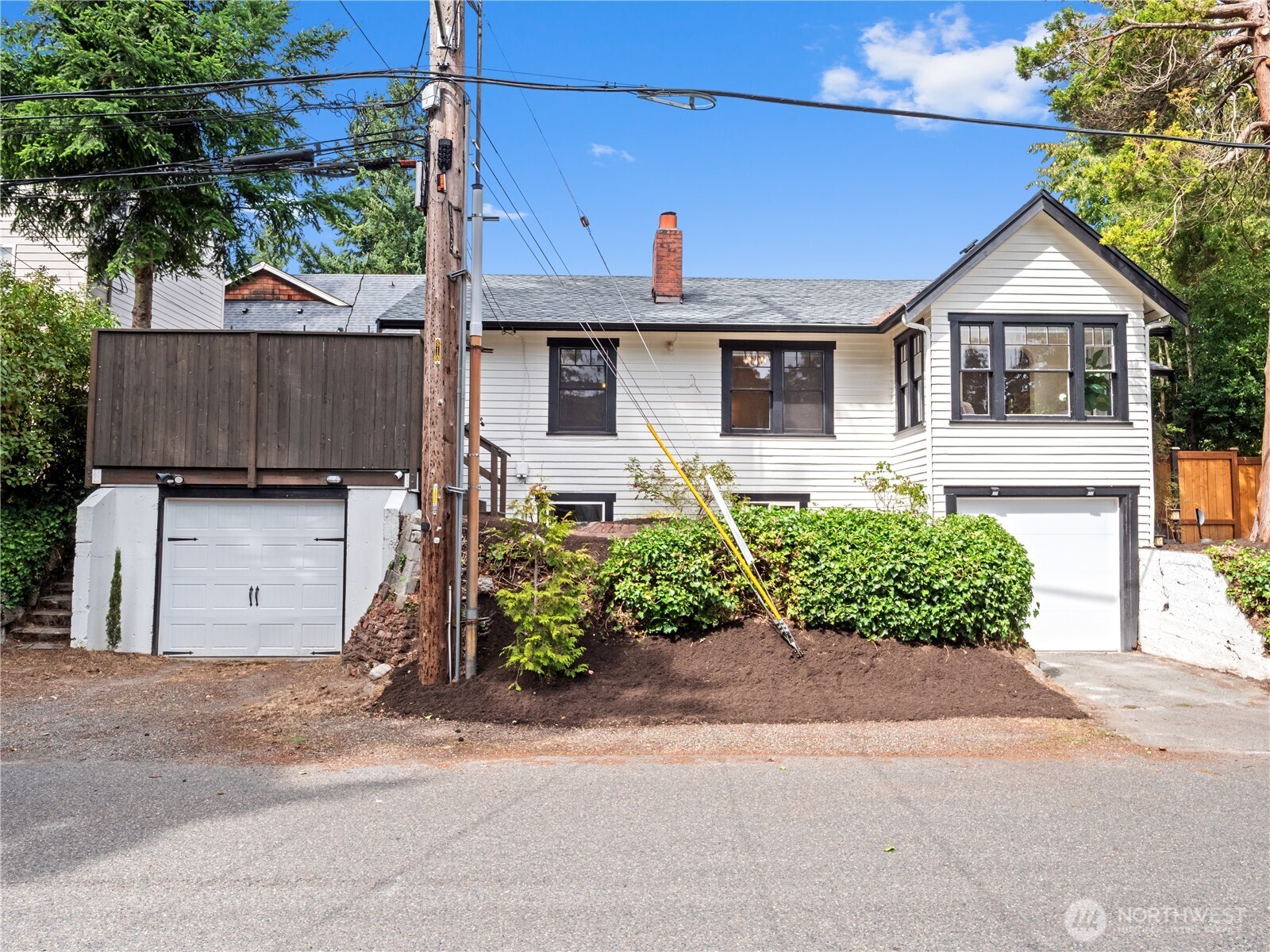 9701 Roosevelt Way Northeast Seattle, WA 98115 - Photo 22 of 33 a front view of a house with a yard and garage