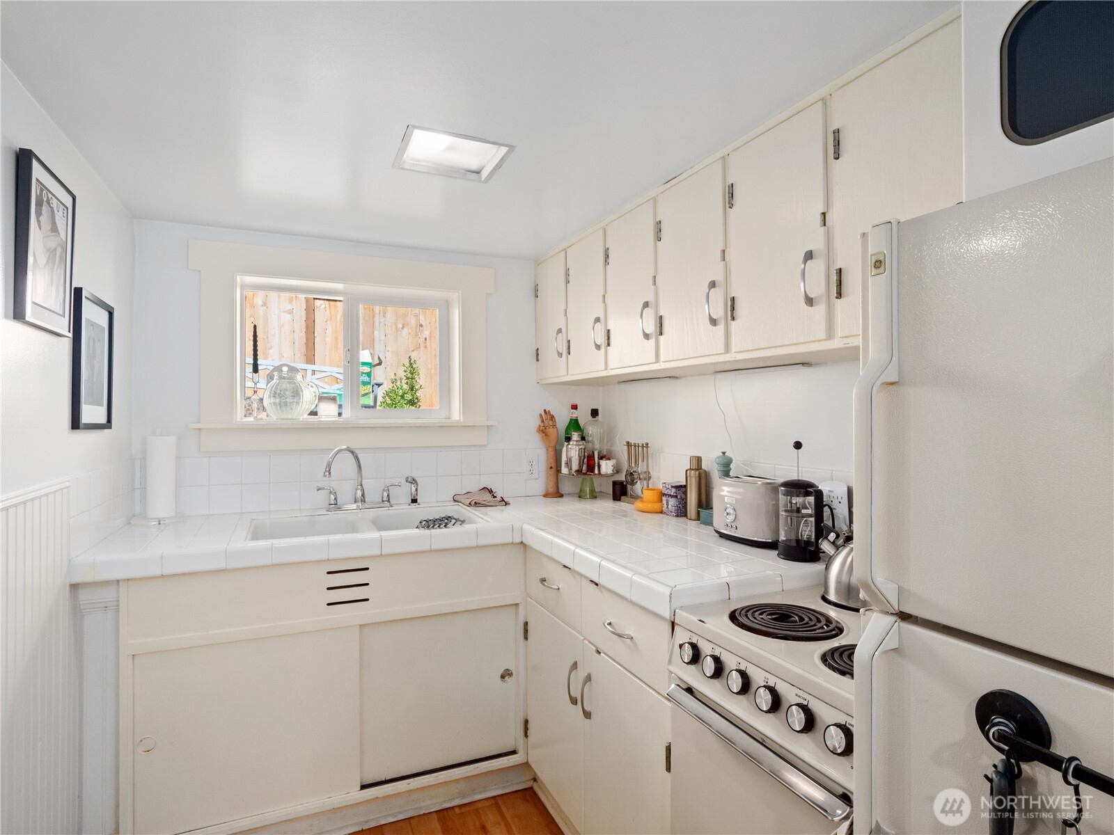 9701 Roosevelt Way Northeast Seattle, WA 98115 - Photo 29 of 33 a kitchen with a sink a stove and cabinets
