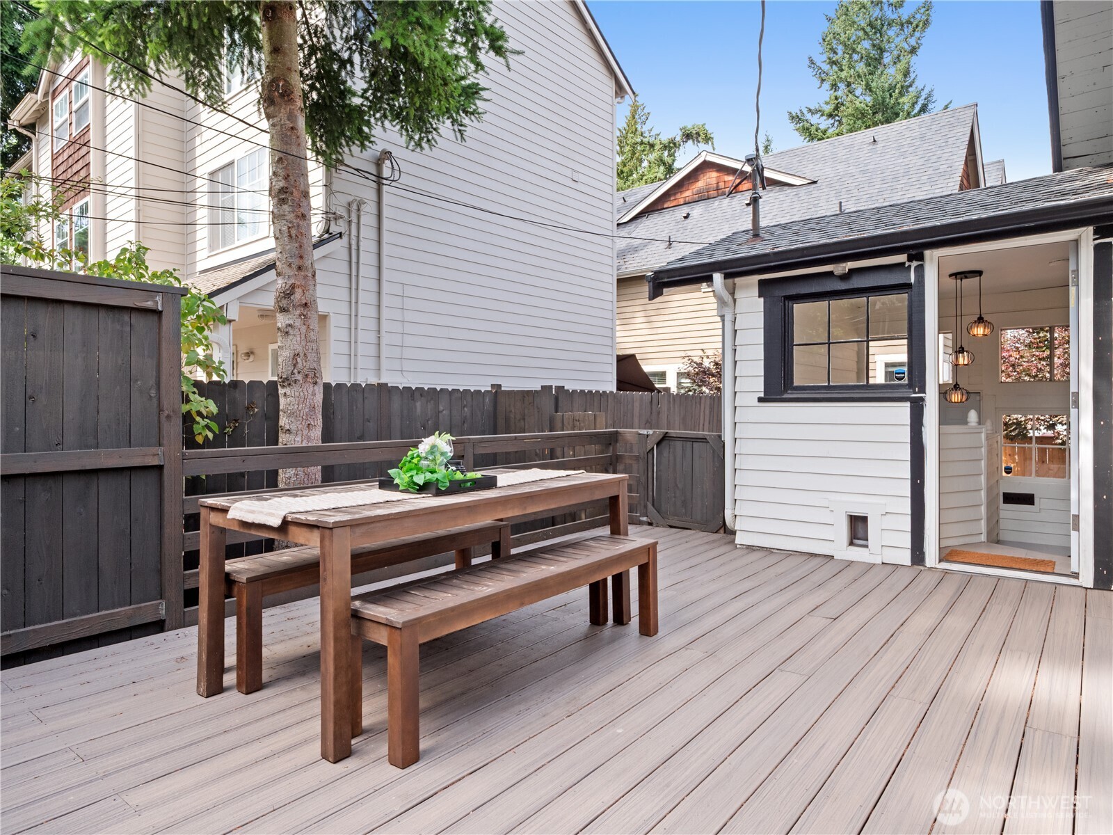 9701 Roosevelt Way Northeast Seattle, WA 98115 - Photo 31 of 33 a backyard of a house with wooden floor chairs sofa and barbecue oven