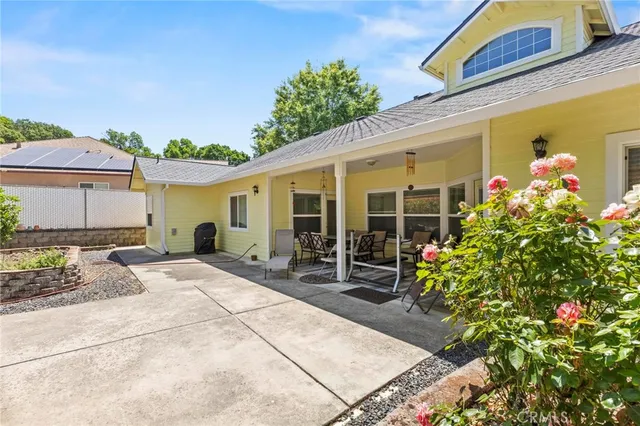 an aerial view of a house with a yard and garden