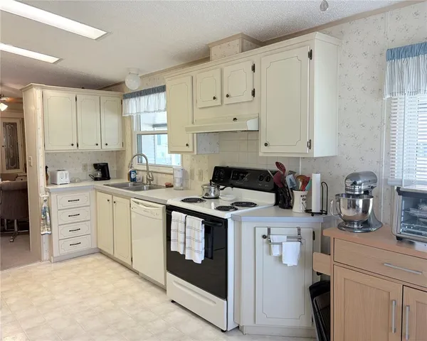 a living room with furniture and a ceiling fan