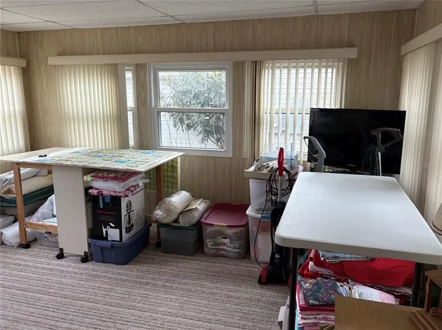 a view of a hallway to a livingroom and a livingroom with furniture