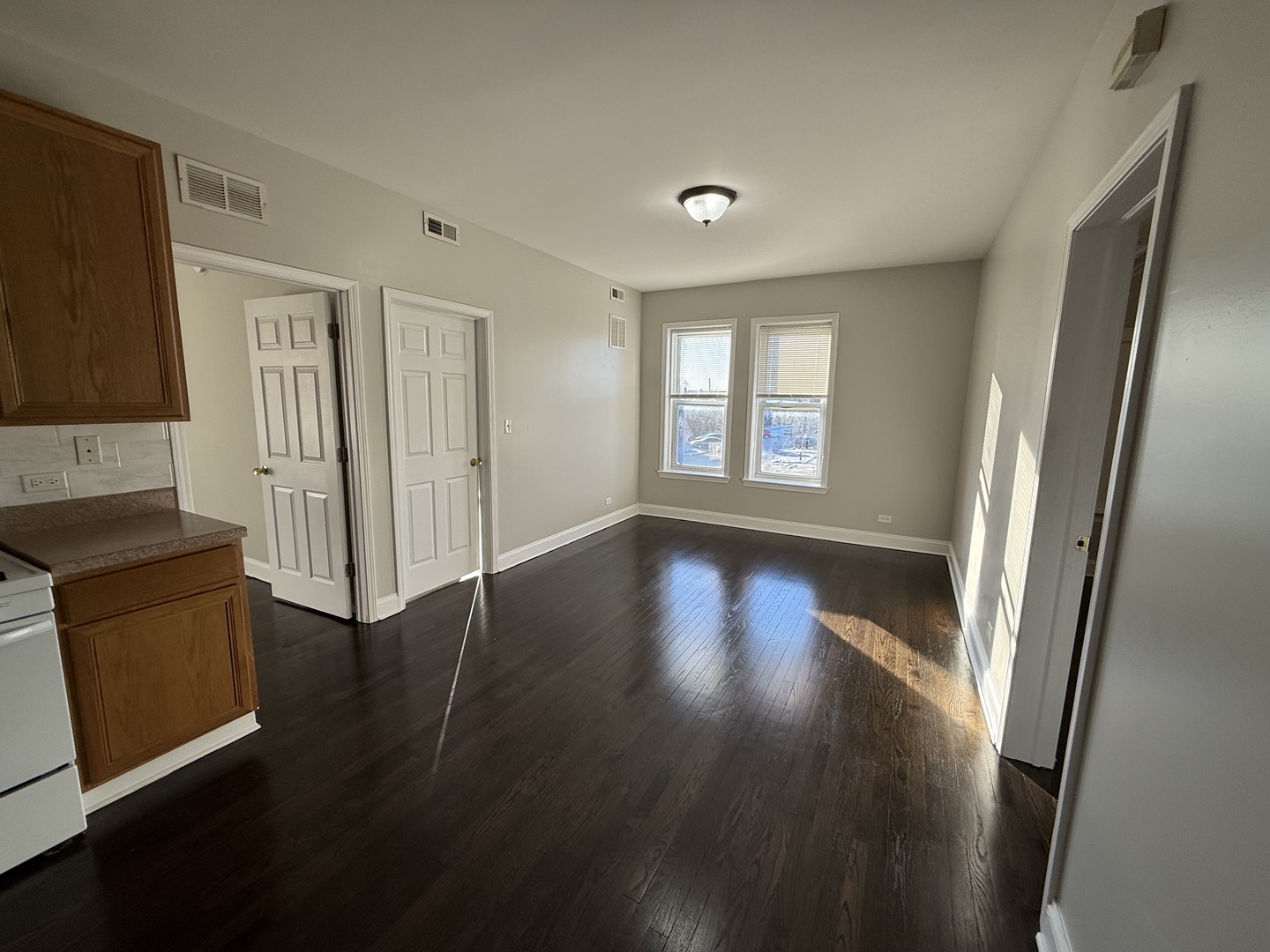6626 Cermak Road, Unit 1F Berwyn, IL 60402 - Photo 2 of 12 an empty room with wooden floor and windows
