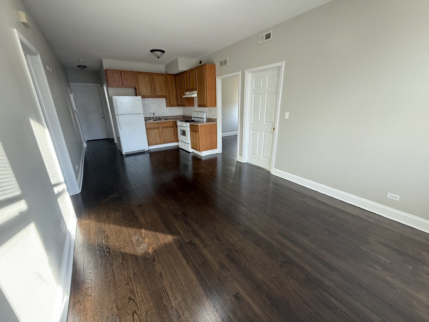 6626 Cermak Road, Unit 1F Berwyn, IL 60402 - Photo 3 of 12 a view of kitchen with refrigerator microwave and wooden floor