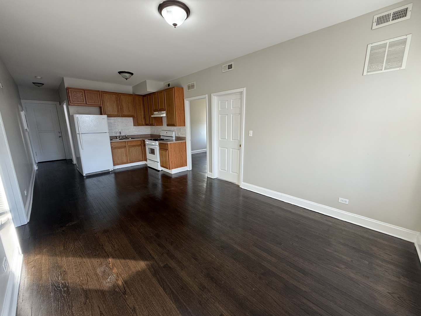 6626 Cermak Road, Unit 1F Berwyn, IL 60402 - Photo 4 of 12 a view of a kitchen with wooden floor and a cabinet