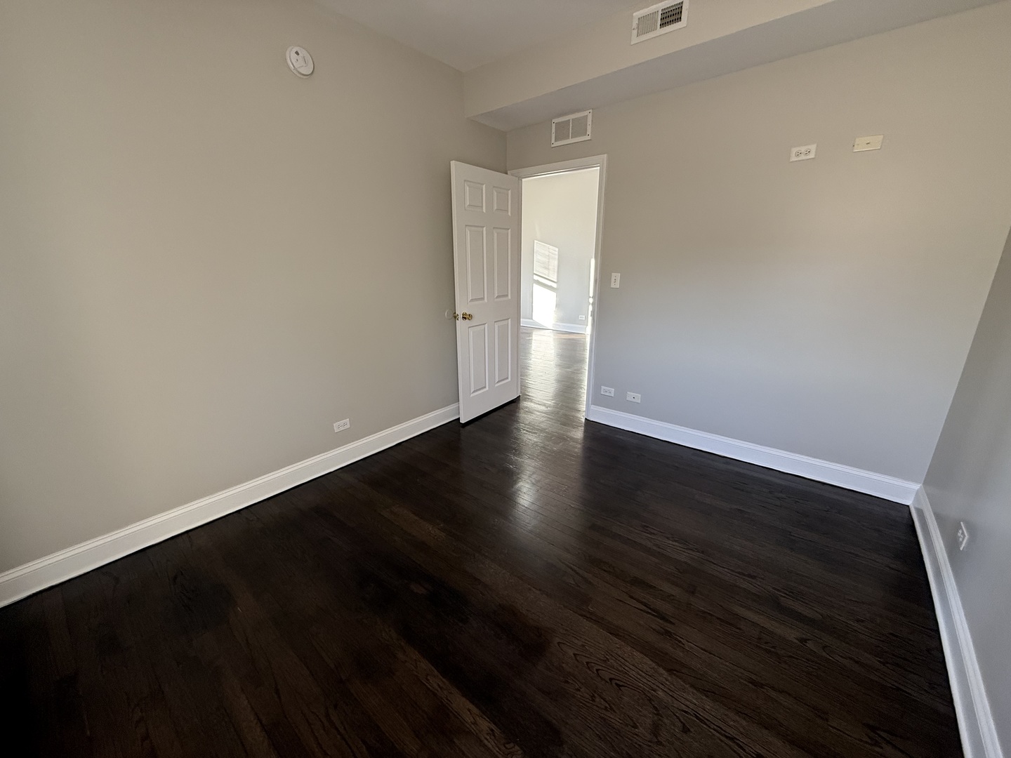 6626 Cermak Road, Unit 1F Berwyn, IL 60402 - Photo 7 of 12 a view of an empty room with wooden floor and a window