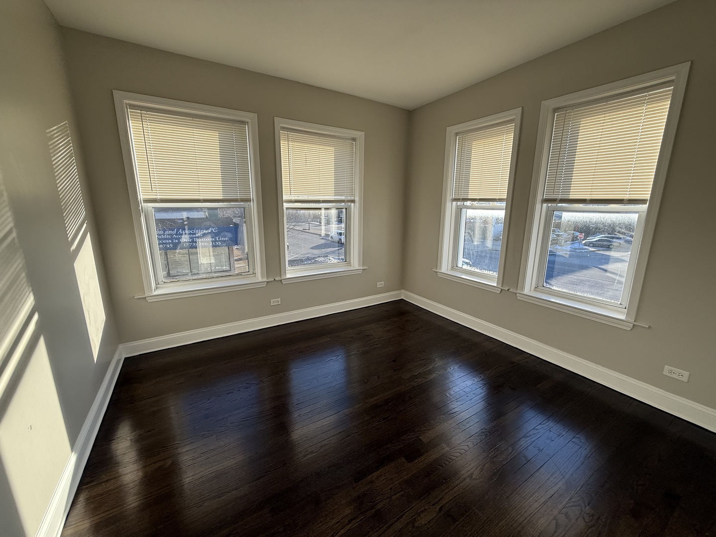 6626 Cermak Road, Unit 1F Berwyn, IL 60402 - Photo 8 of 12 an empty room with wooden floor and windows