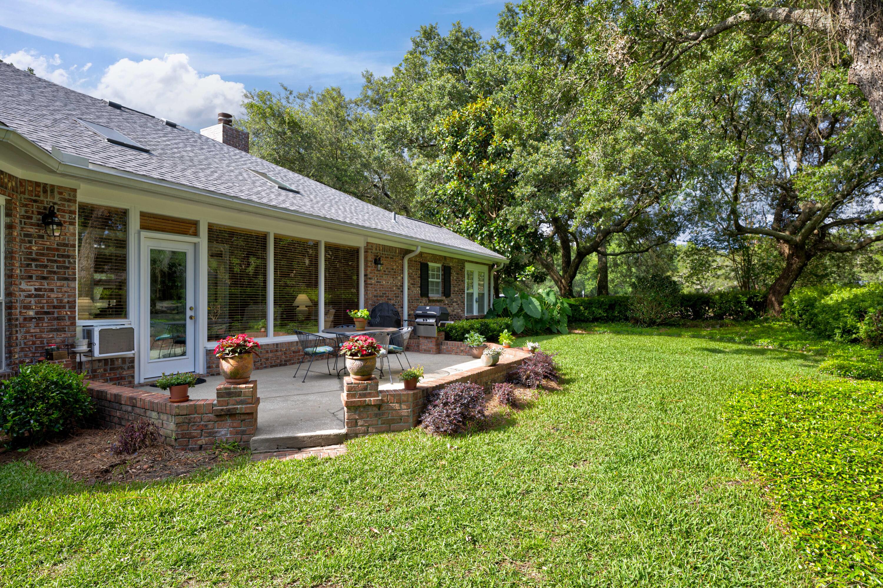 4418 Windrush Drive Niceville, FL 32578 - Photo 17 of 66 a view of a house with backyard sitting area and garden