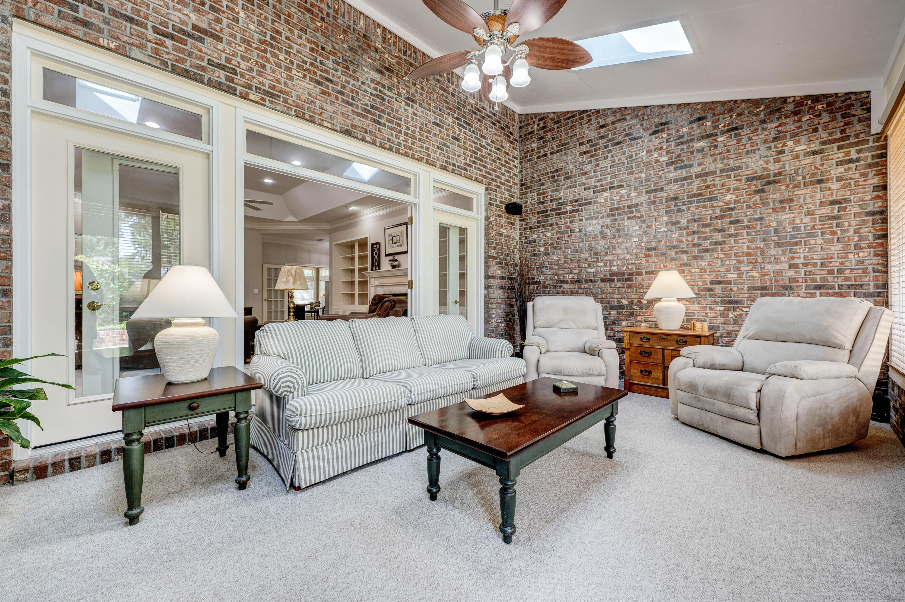 4418 Windrush Drive Niceville, FL 32578 - Photo 19 of 66 a living room with furniture and a chandelier