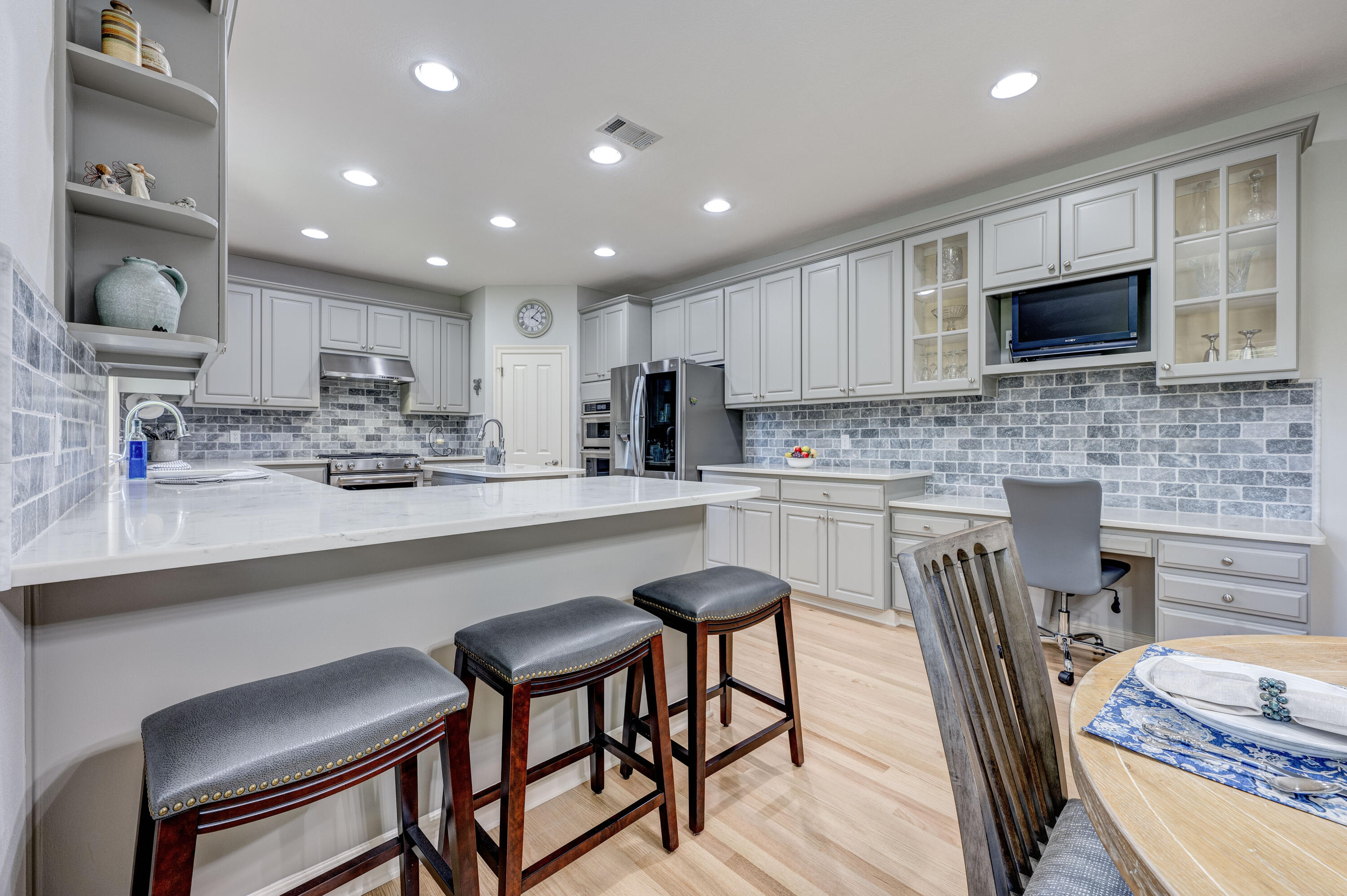 4418 Windrush Drive Niceville, FL 32578 - Photo 24 of 66 a kitchen with stainless steel appliances granite countertop a stove top oven a sink a microwave a refrigerator and cabinets