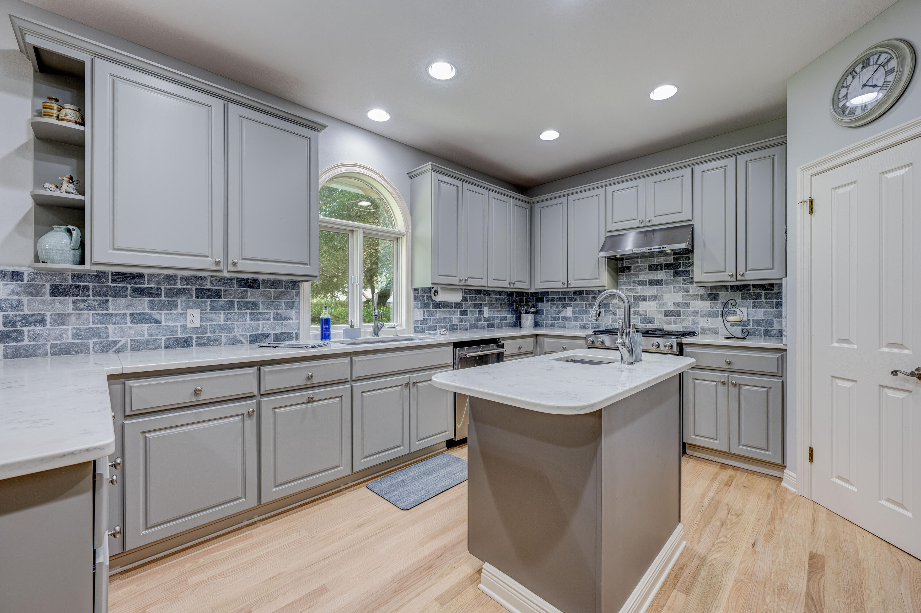 4418 Windrush Drive Niceville, FL 32578 - Photo 25 of 66 a kitchen with kitchen island granite countertop a sink a stove cabinets and counter space