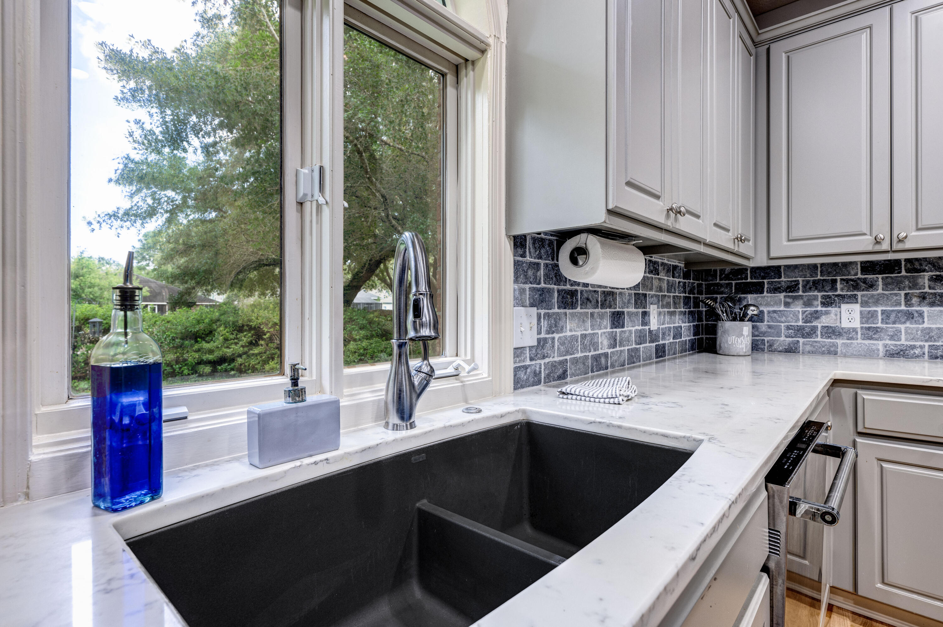 4418 Windrush Drive Niceville, FL 32578 - Photo 27 of 66 a kitchen with stainless steel appliances granite countertop a sink a stove and a microwave