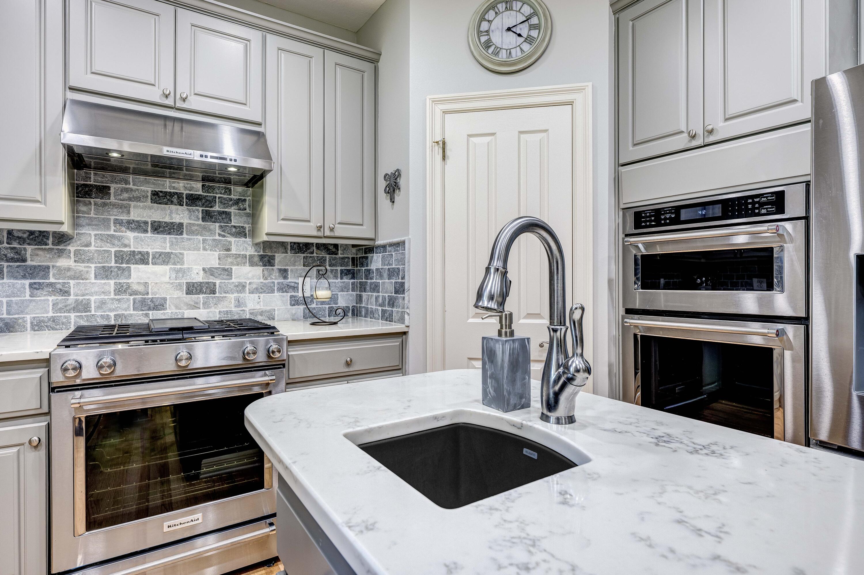 4418 Windrush Drive Niceville, FL 32578 - Photo 28 of 66 a kitchen with granite countertop a stove and a sink with granite countertops