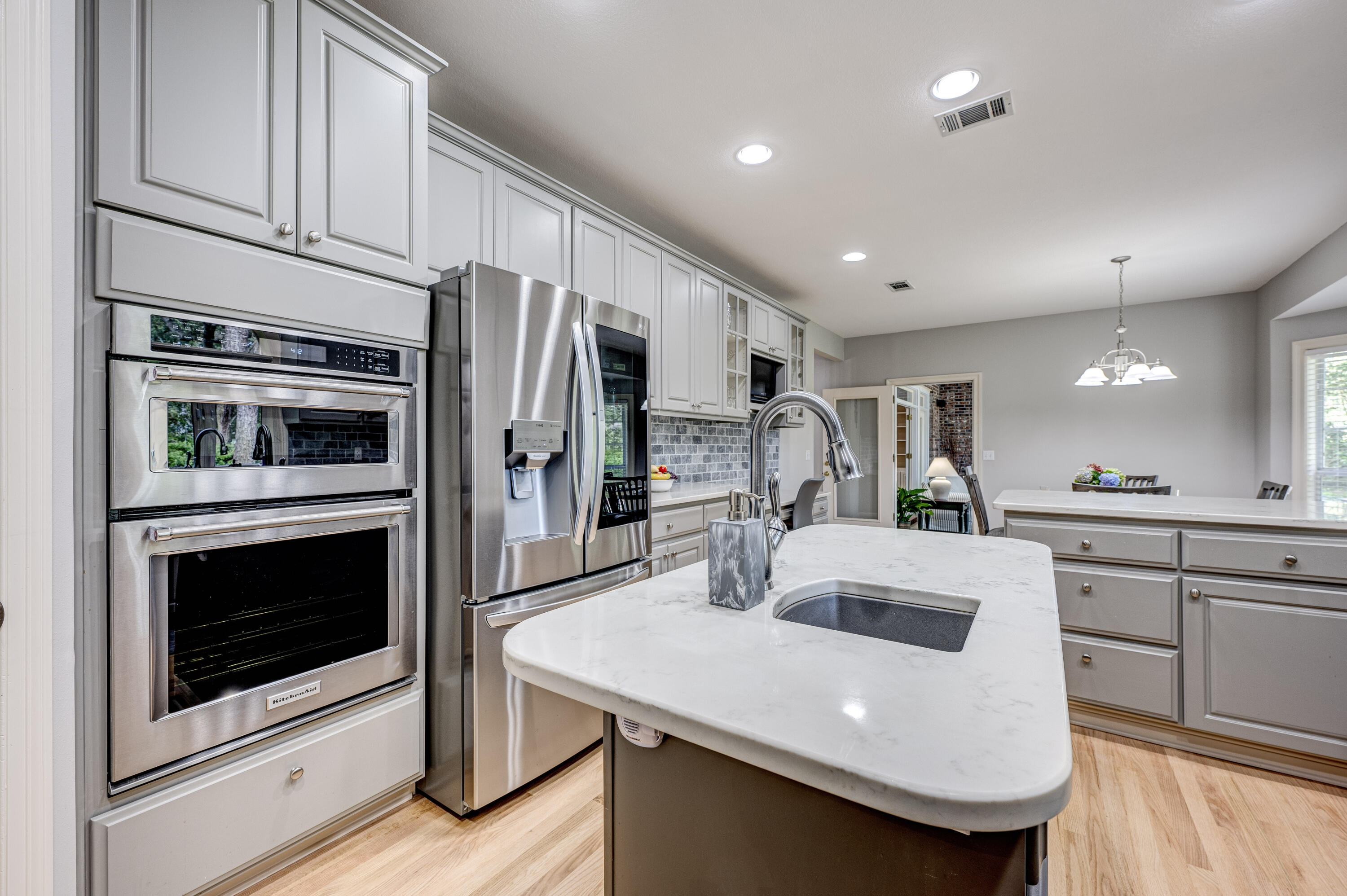 4418 Windrush Drive Niceville, FL 32578 - Photo 29 of 66 a kitchen with stainless steel appliances a stove microwave and cabinets