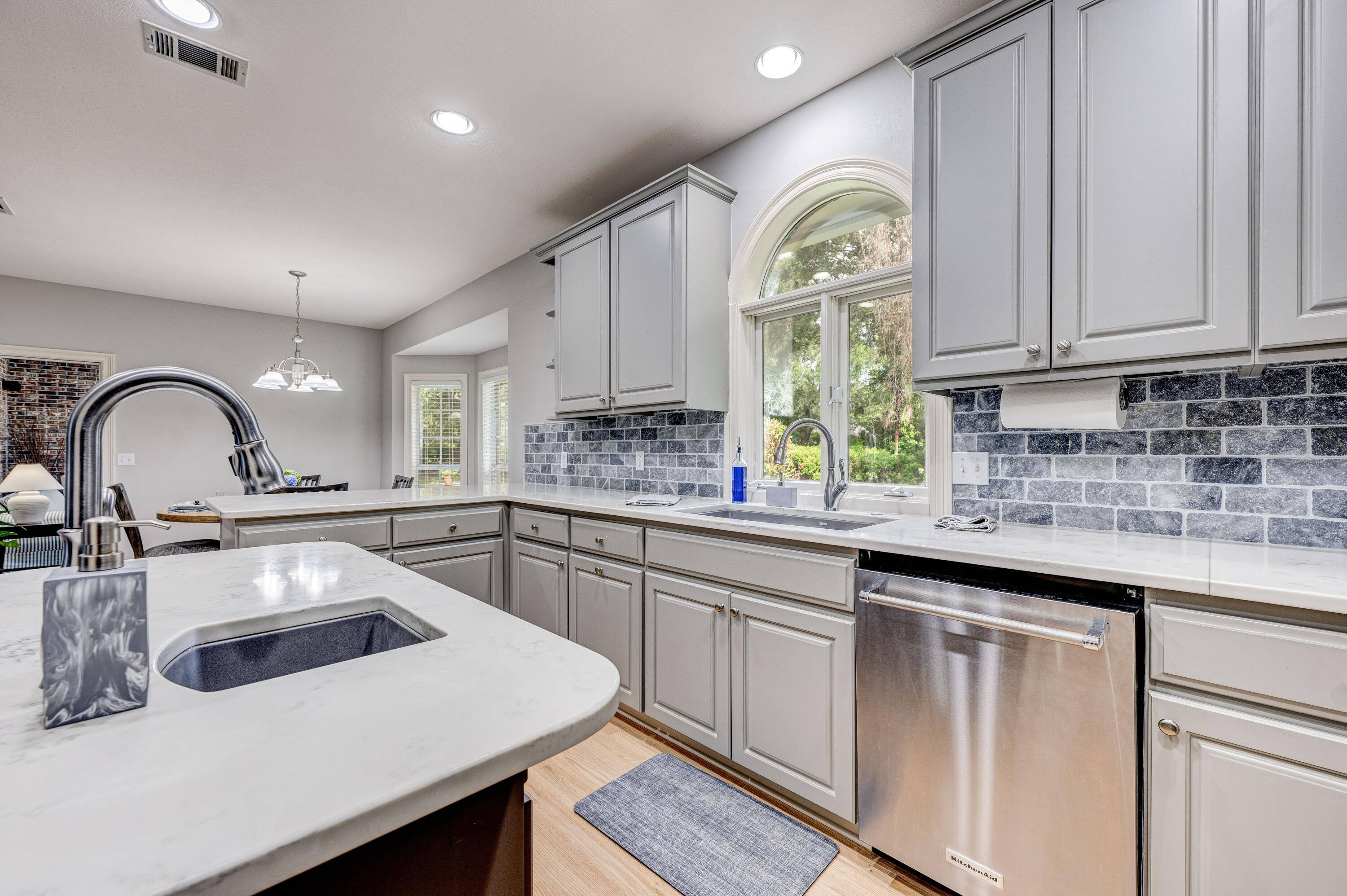 4418 Windrush Drive Niceville, FL 32578 - Photo 30 of 66 a kitchen with white cabinets white appliances and sink